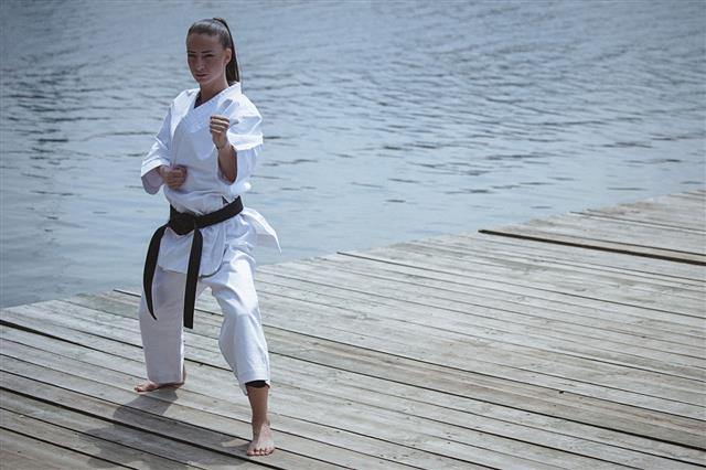 Young Woman Practicing Karate Outdoors