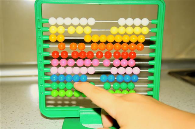 Child Learns Math On Abacus