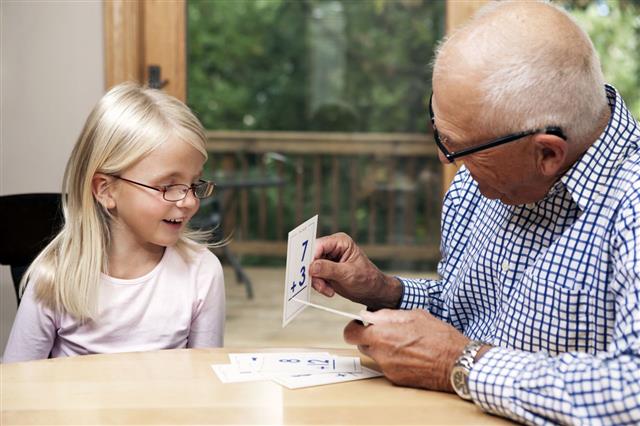 Grandfather And Granddaughter With Flashcards