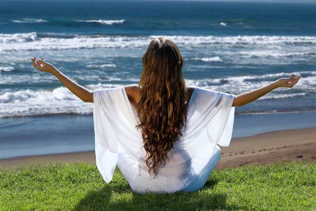 Meditation Of Woman Against Ocean