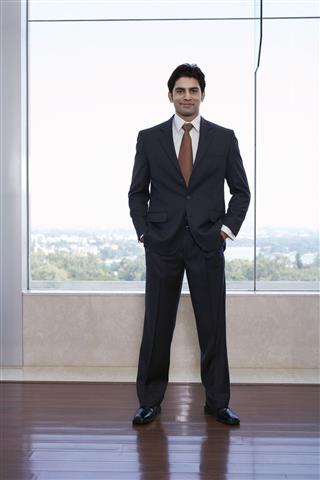 Businessman Standing With Hands In Pockets