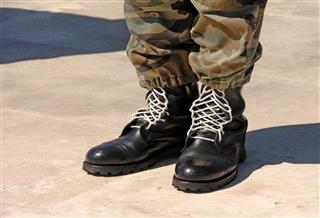 Feet Of Camouflaged Soldier