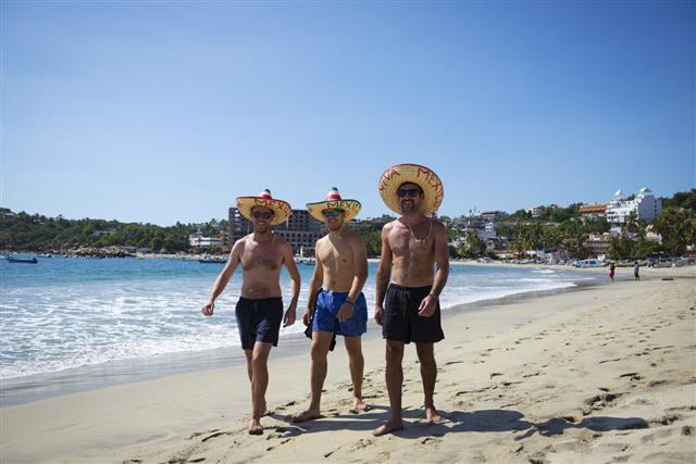 Travelers Wearing Sombreros In Puerto Escondido