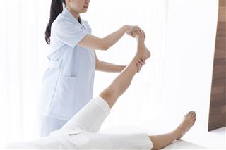 Doctor checking ankle