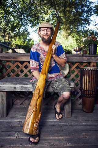 Man Holding A Didgeridoo