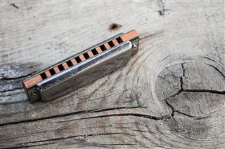 Blues Harmonica On A Wooden Background