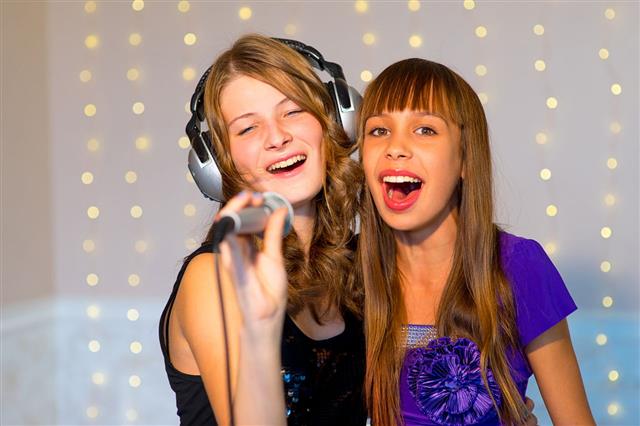 Pair Of Girls Singing Karaoke