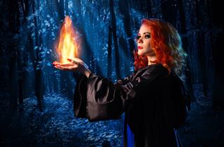 Witch In Night Forest Holds Fire