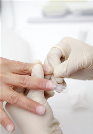 Manicure process on female hand, Making nail extension