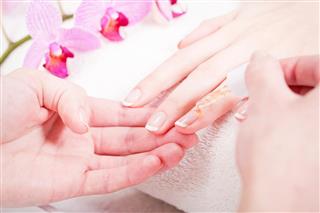 Manicure making in beauty spa salon