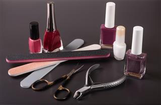 Scissors, nail files and clippers manicure with polish bottles