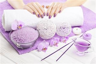 Beautiful pink manicure with orchid and towel