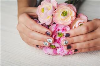 Violet nail art with printed white bow