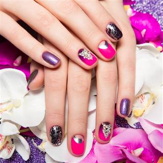 Beautiful colorful manicure with bubbles and crystals on female hand