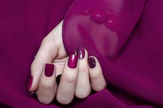 Woman hand with bright pink manicure