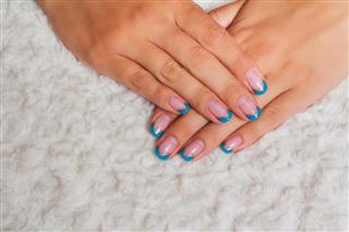 French nail art with light blue and gold lines