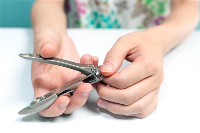 Woman cutting nail