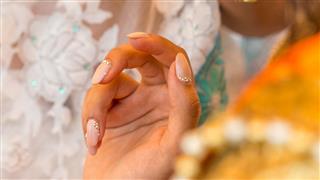 Hand with rhinestones on the fingernails from India