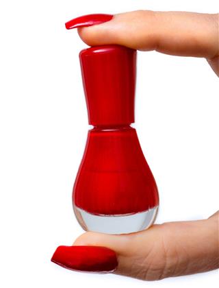 Woman holding her red bottle of nail polish