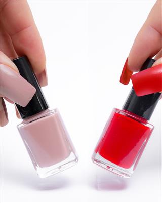 Lifting Bottles of nude and red colored nail polish