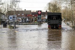 Army Truck Drives Down Flooded Road