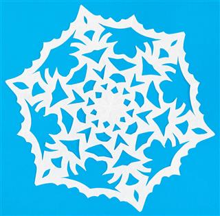 White Snowflake On Blue Paper
