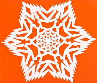 White Snowflake On Orange Paper