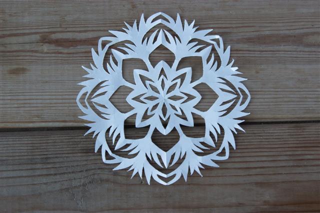 Paper Snowflake On The Wooden Table