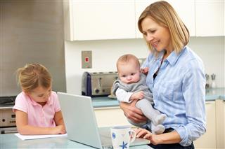 Mother With Children Using Laptop