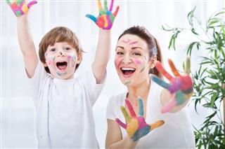 Child Painting With Mom
