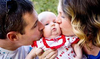 Parents Kissing Baby Happy Family