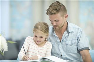 Father Homeschooling His Daughter