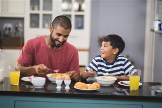 Man With His Son Having Breakfast