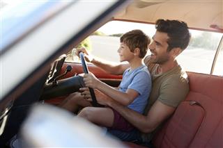 Father Teaching Son Drive Car