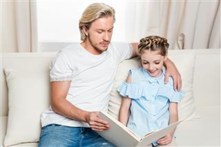 Father And Daughter Reading Book