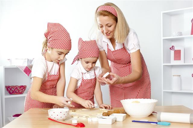 Mother And Daughters Making Cookies