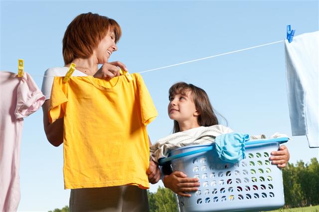 Mother And Daughter Handing Laundry