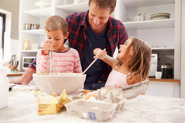 Father Baking With Children Having Fun