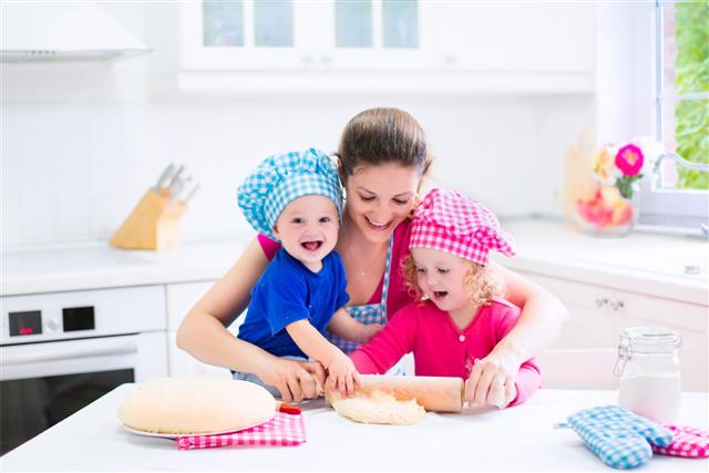 Mother And Kids Baking Pie