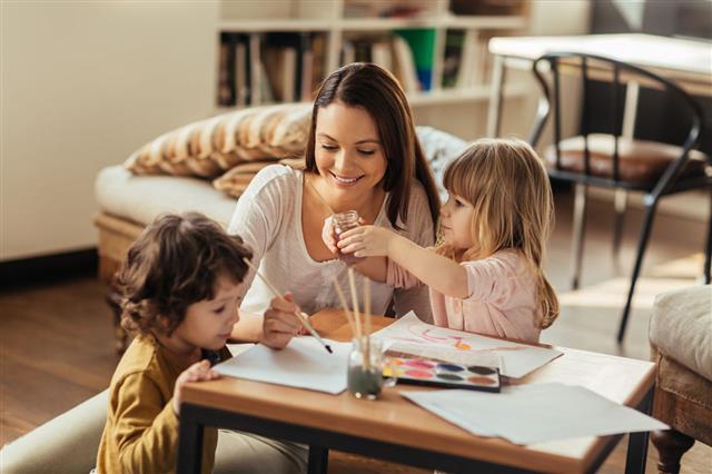 Young Mother Painting With Kids
