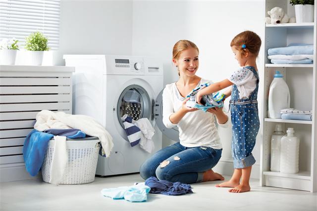 Mother And Child In Laundry Room
