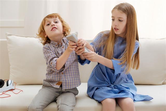 Adorable Active Children Fighting For Remote