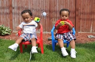 Two Toddlers Sitting Playing