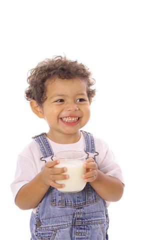 Happy Toddler With A Glass Of Milk