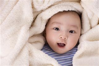 Beautiful Baby Under White Blanket