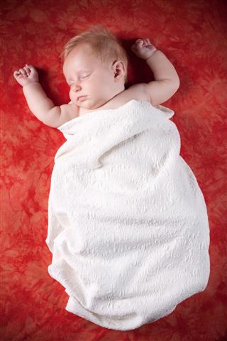 Baby Wrapped In White Blanket Sleeping