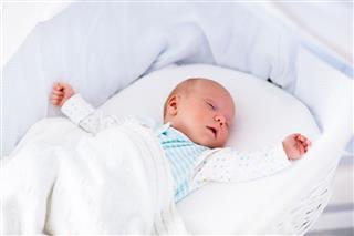 Cute Newborn Baby In White Bed