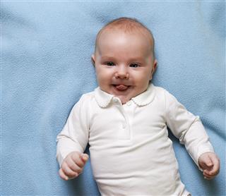 Small Child In Blue Diaper Smiling