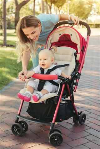 Baby In Pink Stroller With Parents
