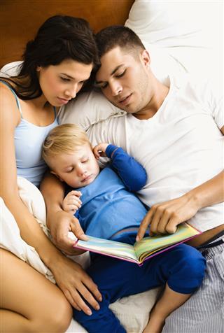 Family On Bed Reading